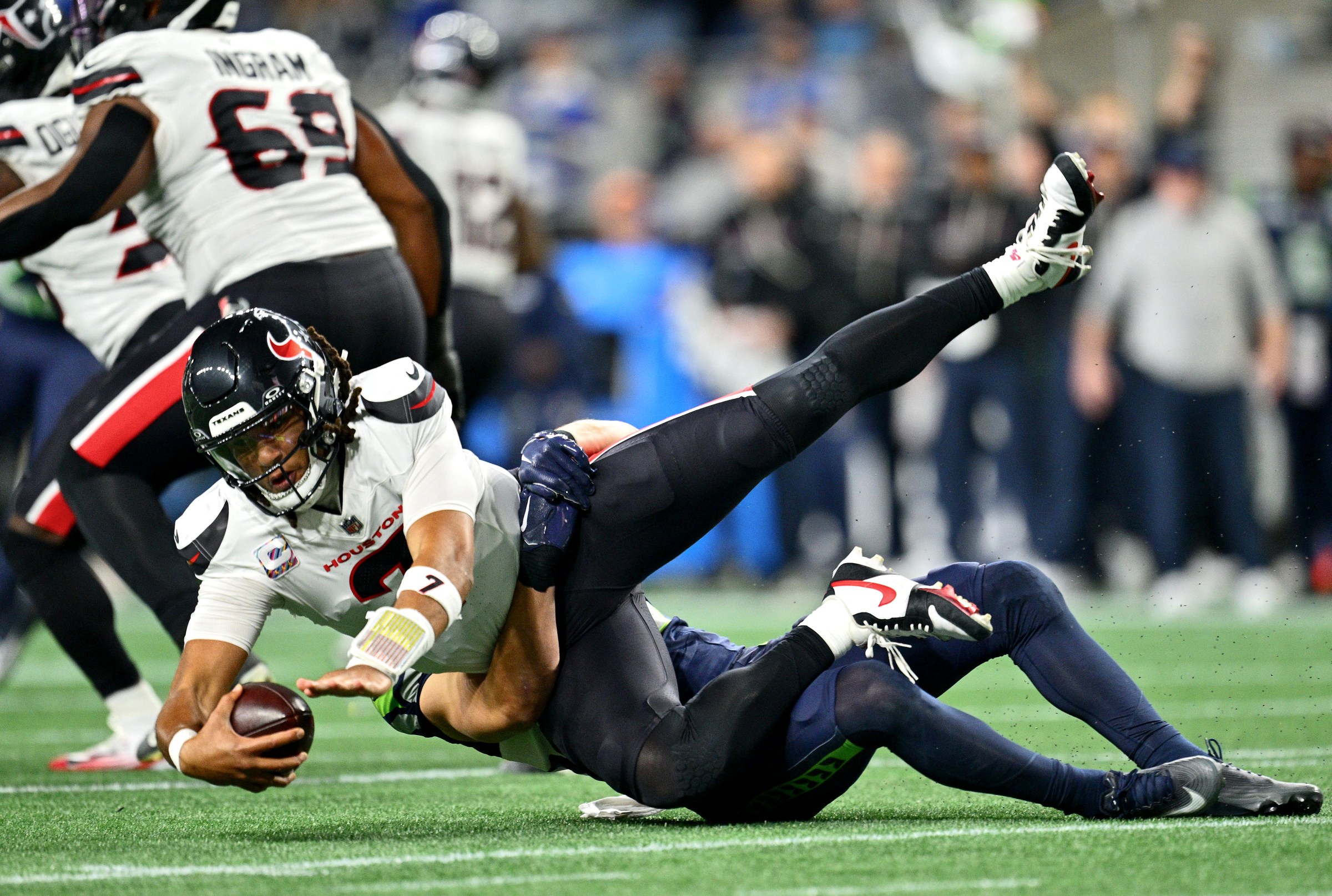 SEATTLE, WASHINGTON - OCTOBER 20: Ty Okada #39 of the Seattle Seahawks sacks C.J. Stroud #7 of the Houston Texans during the third quarter at Lumen Field on October 20, 2025 in Seattle, Washington. (Photo by Jane Gershovich/Getty Images)