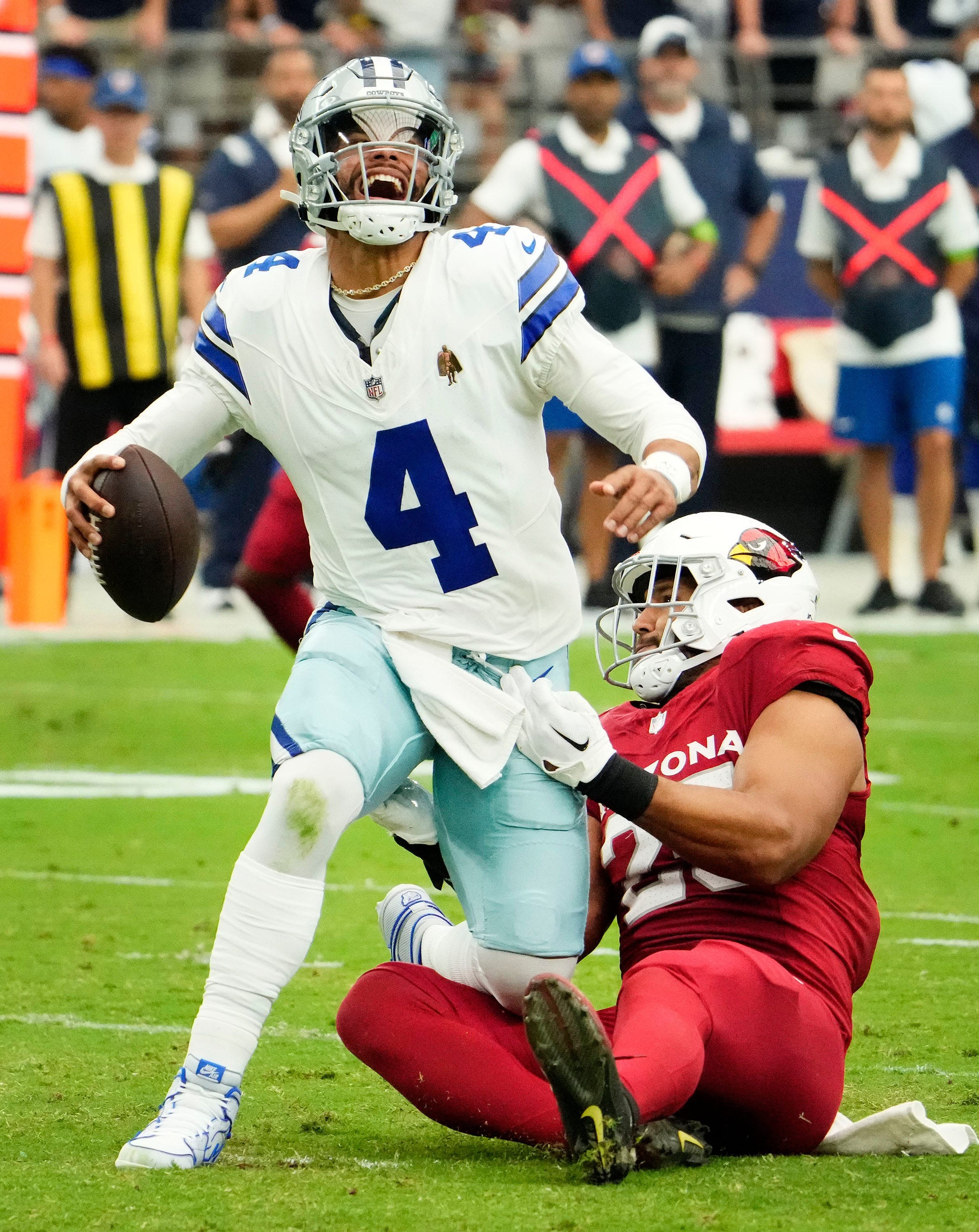 Sep 24, 2023; Glendale, Arizona, USA; Arizona Cardinals linebacker Zaven Collins (25) sacks Dallas Cowboys quarterback Dak Prescott (4) in the first half at State Farm Stadium. Mandatory Credit: Rob Schumacher-Arizona Republic