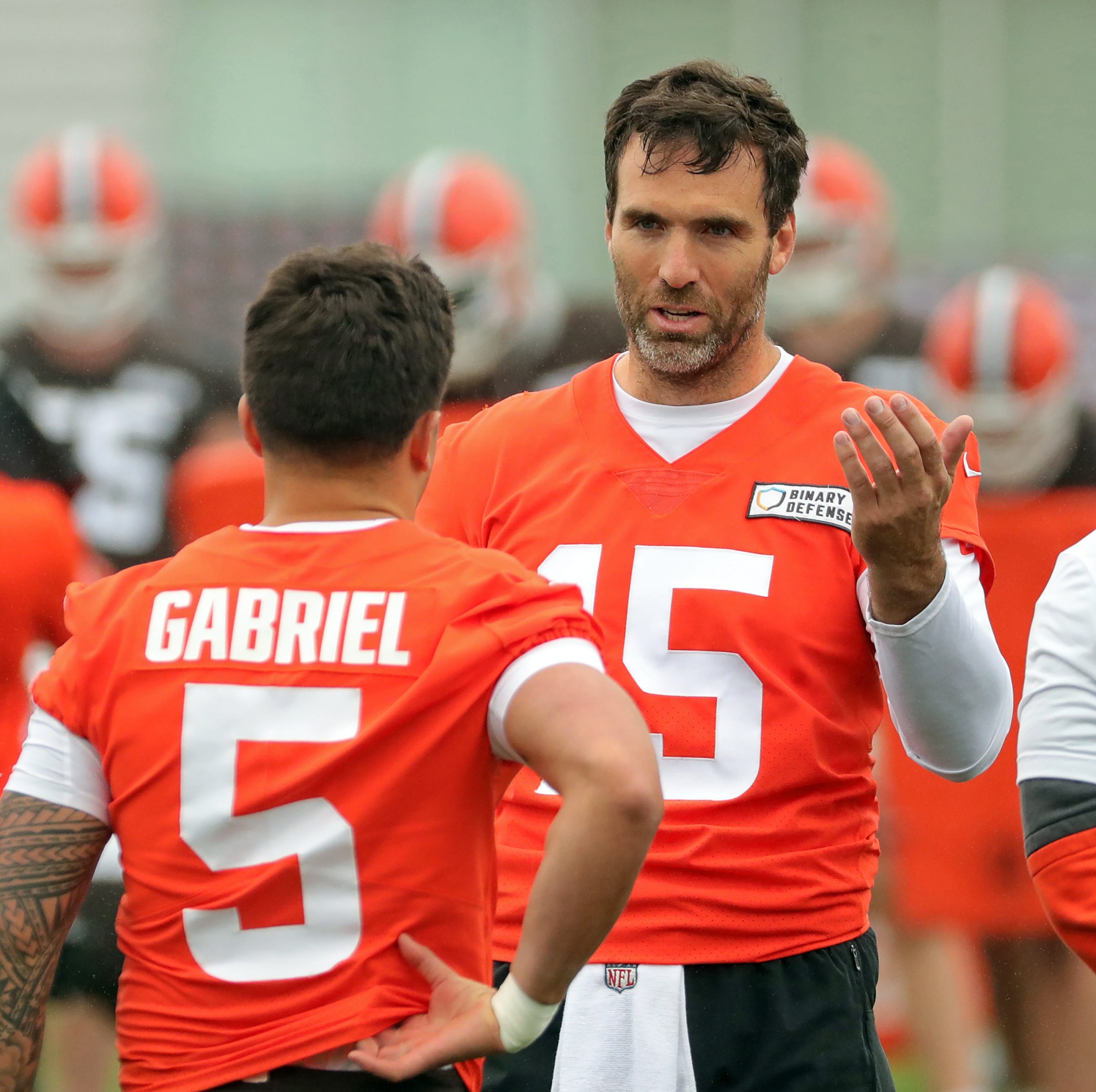 Cleveland Browns quarterback Joe Flacco, facing, chats with rookie quarterback Dillon Gabriel (5) during an NFL practice at the Cleveland Browns training facility on Wednesday, May 28, 2025, in Berea, Ohio.