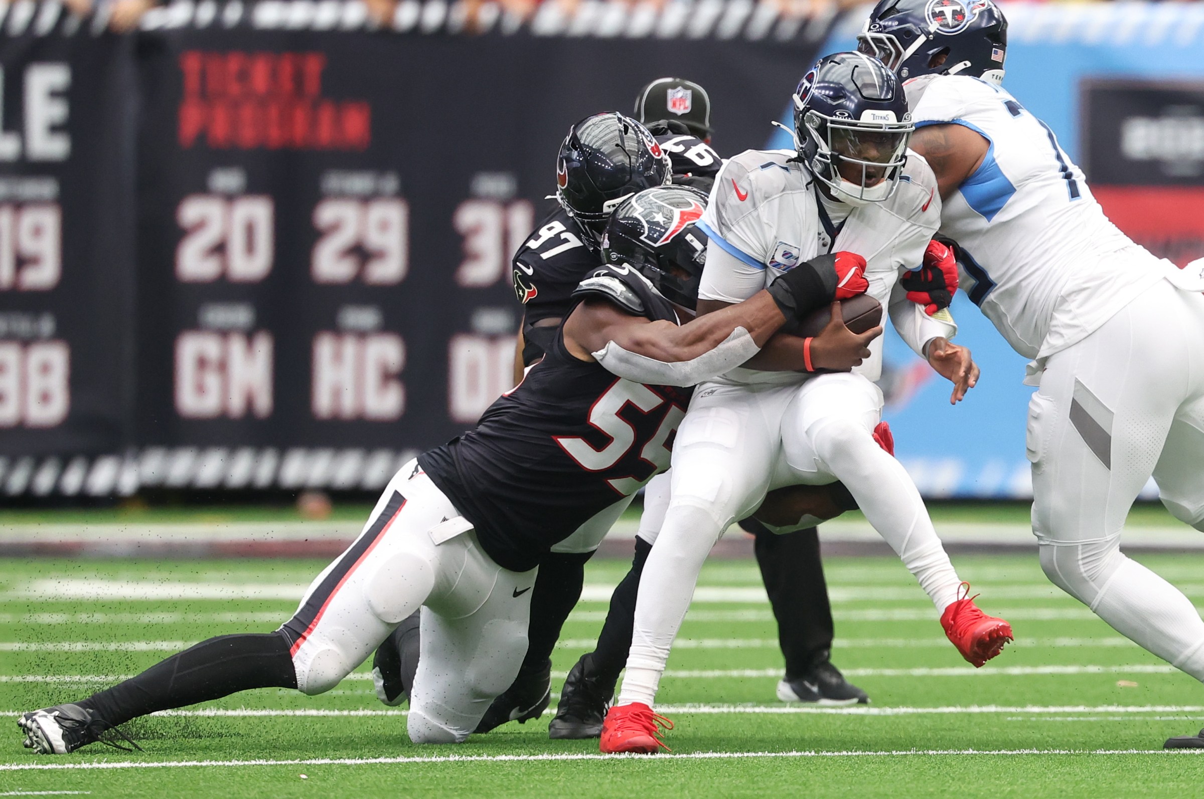 Sep 28, 2025; Houston, Texas, USA; Houston Texans defensive end Danielle Hunter (55) sacks Tennessee Titans quarterback Cam Ward (1) during the first half at NRG Stadium. Mandatory Credit: Troy Taormina-Imagn Images