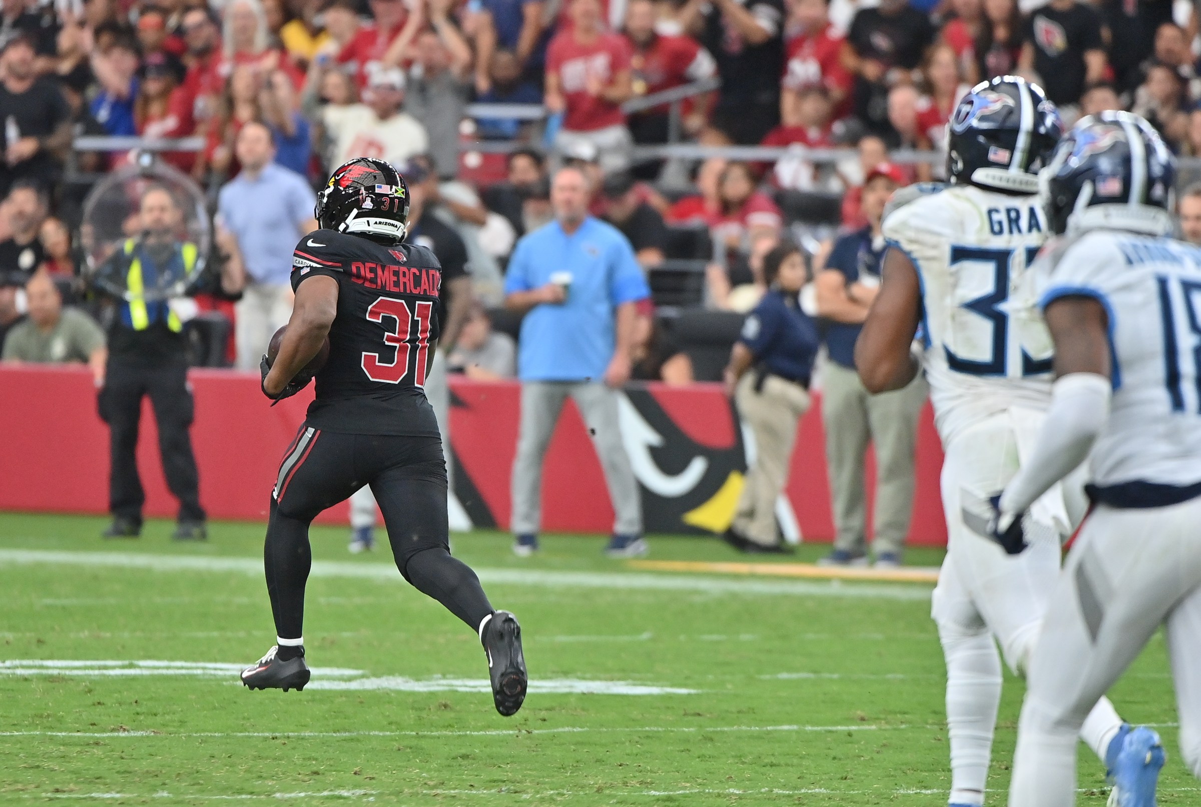 Oct 5, 2025; Glendale, Arizona, USA; Arizona Cardinals running back Emari Demercado (31) runs the ball for 71 yards before fumbling against the Tennessee Titans during the fourth quarter at State Farm Stadium. Mandatory Credit: Matt Kartozian-Imagn Images