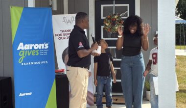 Former Falcon Warrick Dunn helps two families furnish new homes