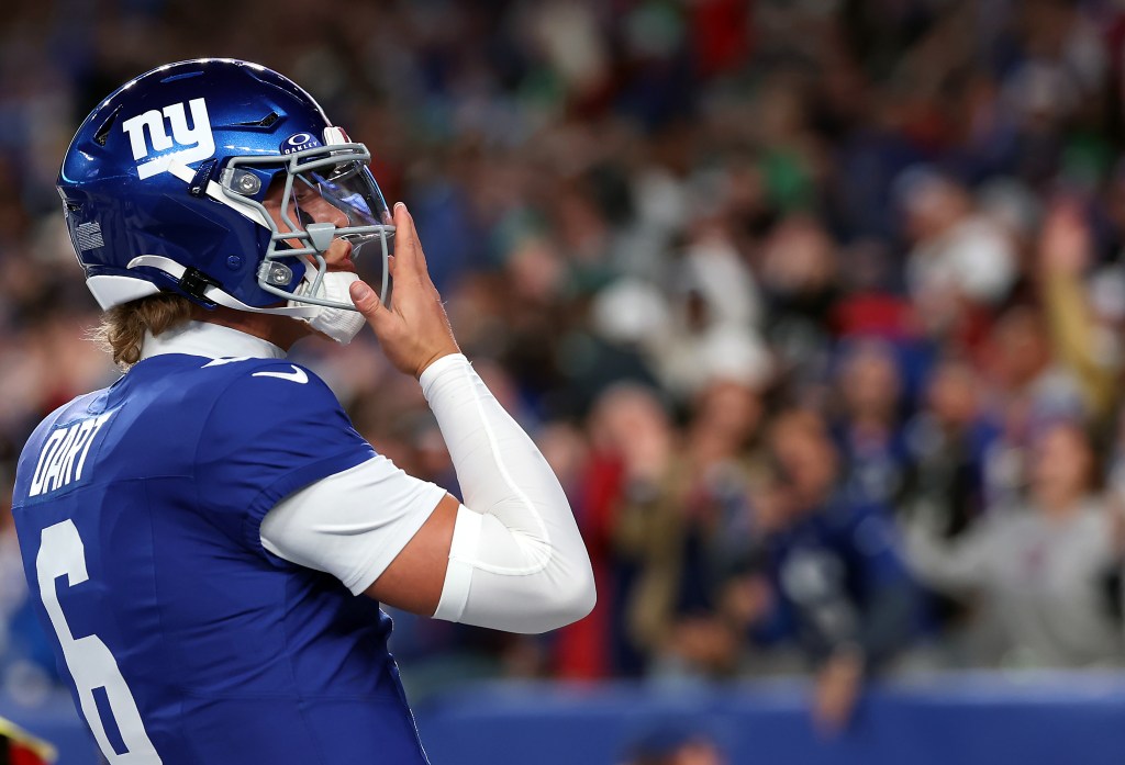 Jaxson Dart #6 of the New York Giants reacts after scoring a touchdown.