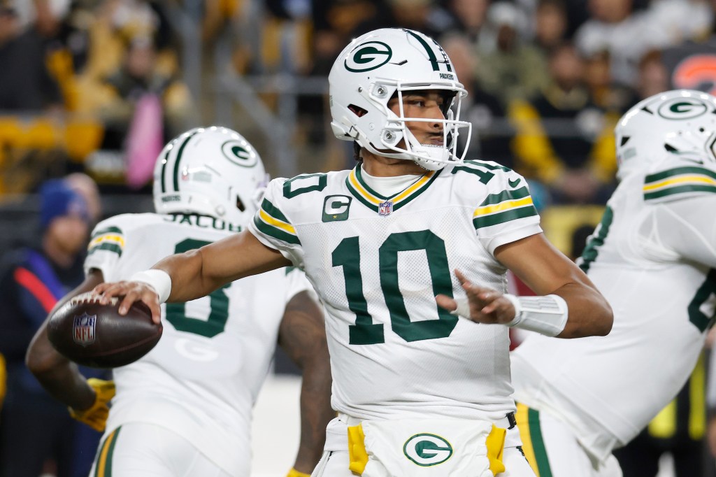 Green Bay Packers player Jordan Love throwing the football.