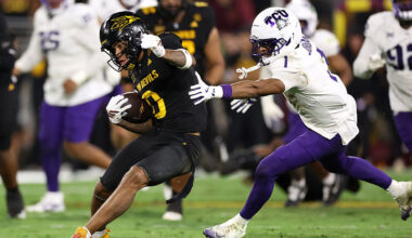 Wide receiver Jordyn Tyson #0 of the Arizona State Sun Devils slips past safety Austin Jordan #1 of...