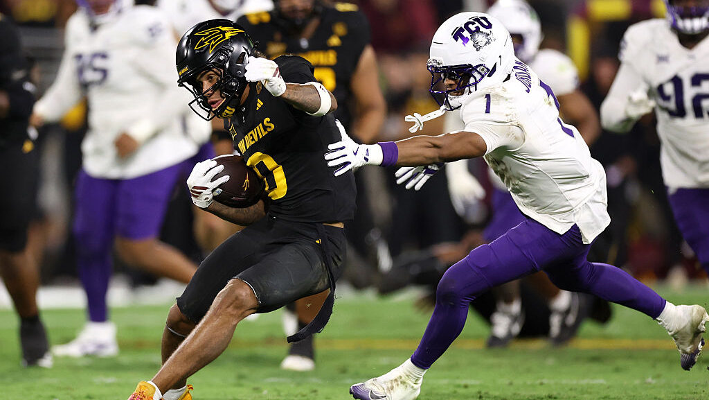Wide receiver Jordyn Tyson #0 of the Arizona State Sun Devils slips past safety Austin Jordan #1 of...