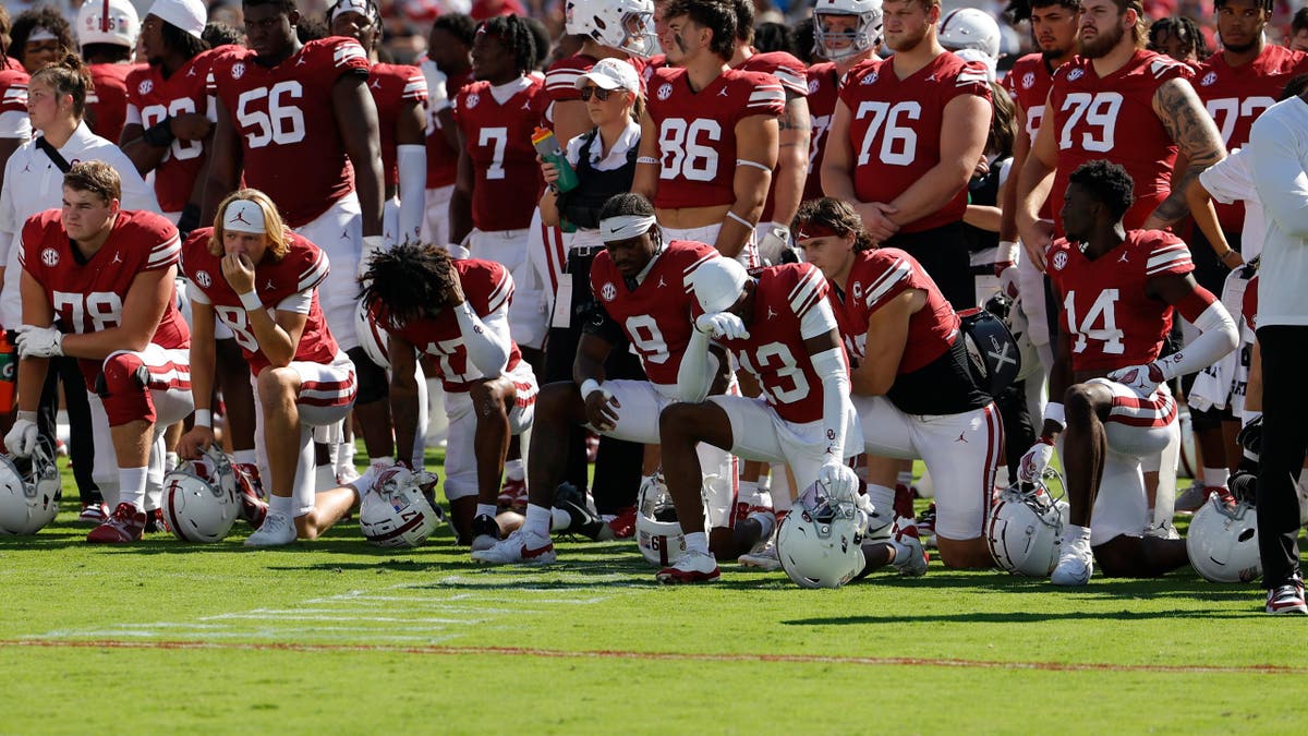 Oklahoma football players taking a knee
