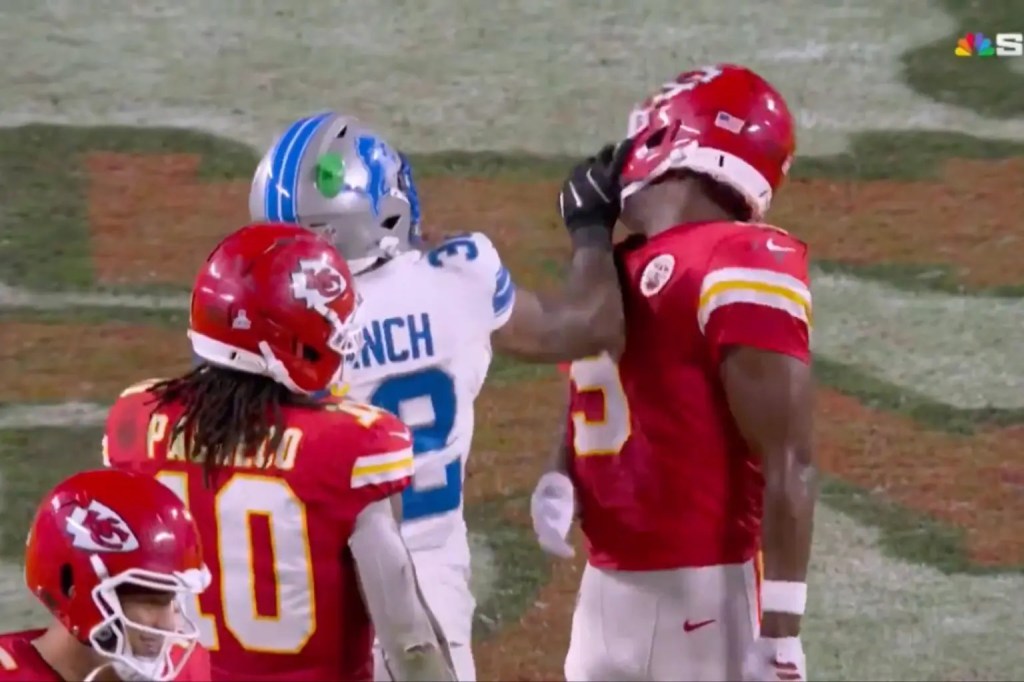 A Detroit Lions player in white jersey number 2 and a Kansas City Chiefs player in red jersey number 5 argue on the field, while another Chiefs player in red jersey number 10 watches.