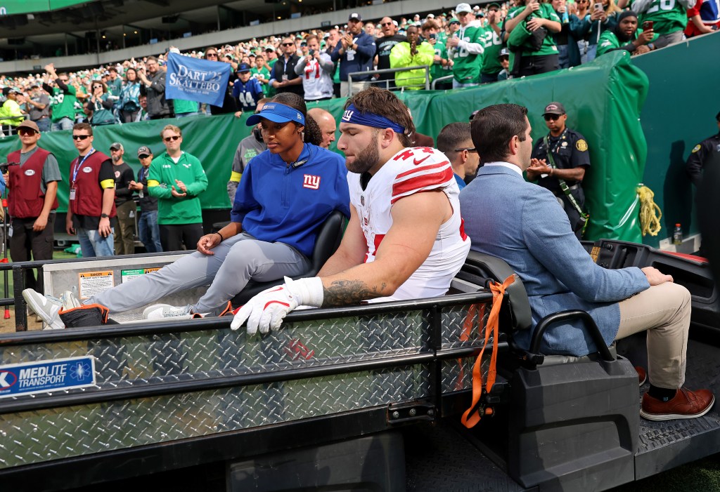 New York Giants running back Cam Skattebo #44 is carted off the field after he is tackled by Philadelphia Eagles linebacker Zack Baun #53 and twists his ankle during the second quarter.