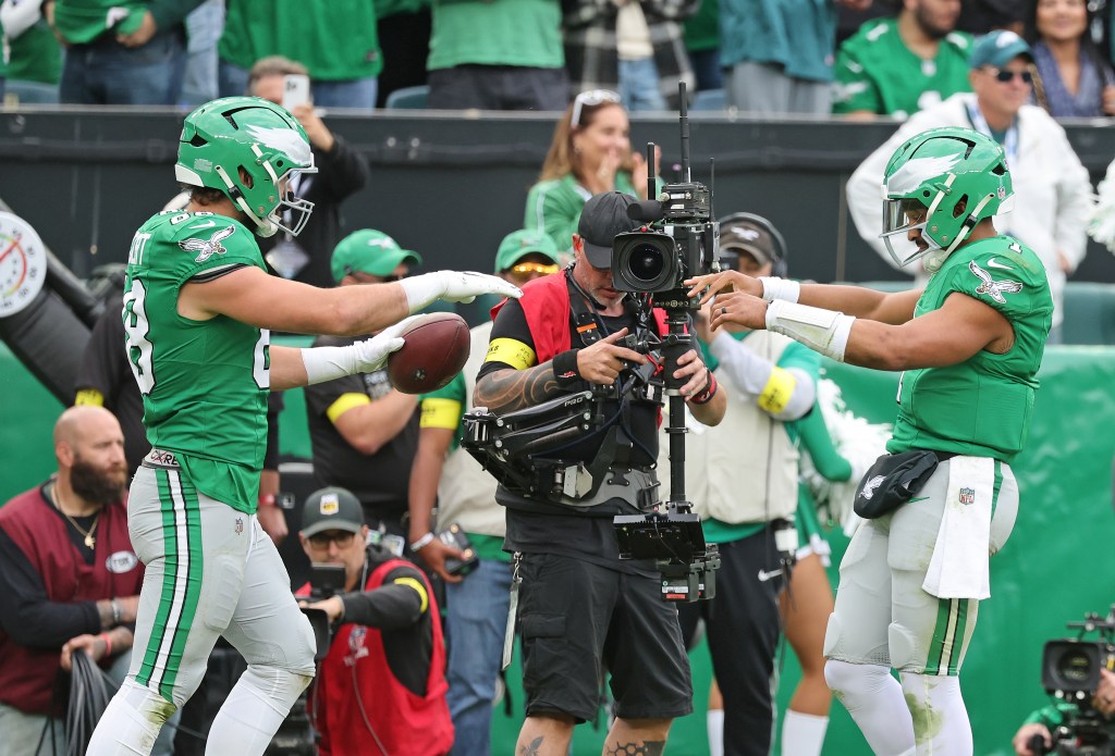 Philadelphia Eagles tight end Dallas Goedert #88 celebrates with Philadelphia Eagles quarterback Jalen Hurts #1 after he scores a touchdown during the fourth quarter.
