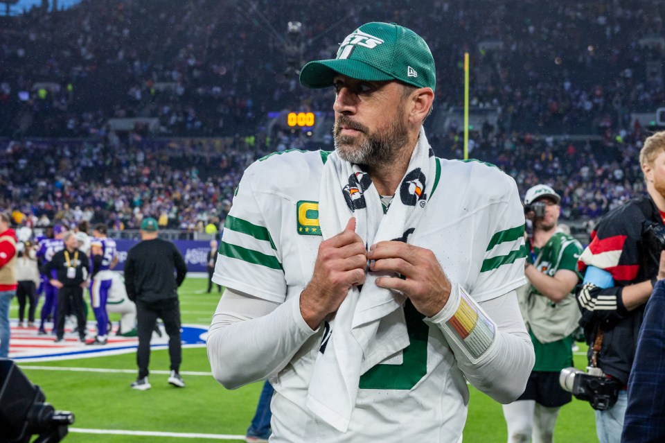 New York Jets quarterback Aaron Rodgers on the field after a game.