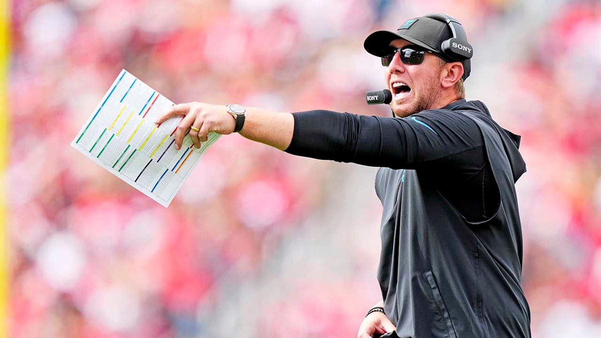 Liam Coen yells on the sideline