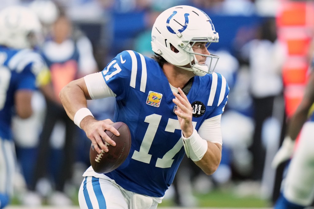 Colts quarterback Gardner Minshew holding a football during a game.