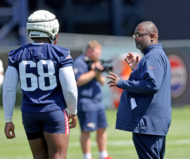 Patriots defensive coordinator Terrell Williams talks with defensive tackle Isaiah Iton (68) during training camp in July in Foxboro. (Photo By Matt Stone/Boston Herald)