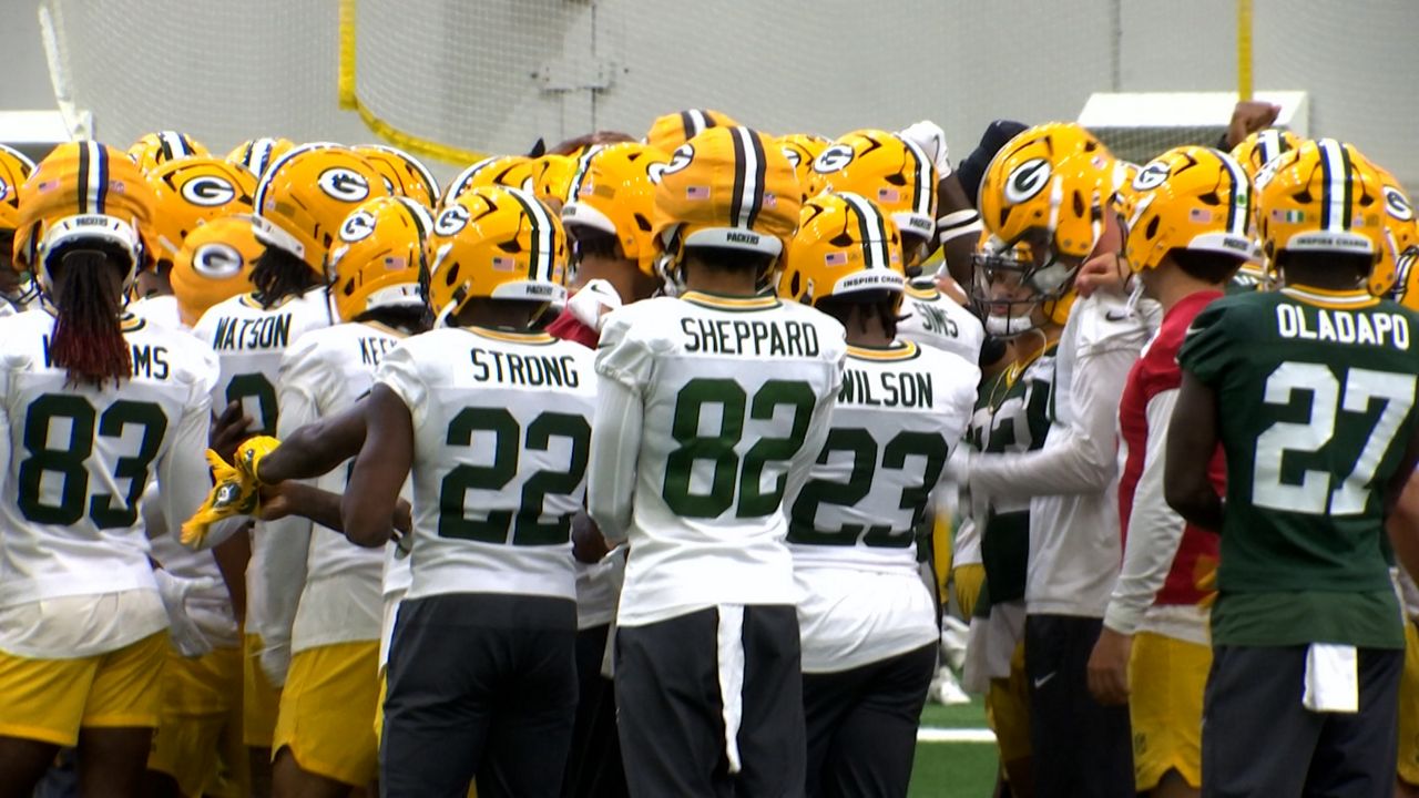 Packers in a hudle at practice