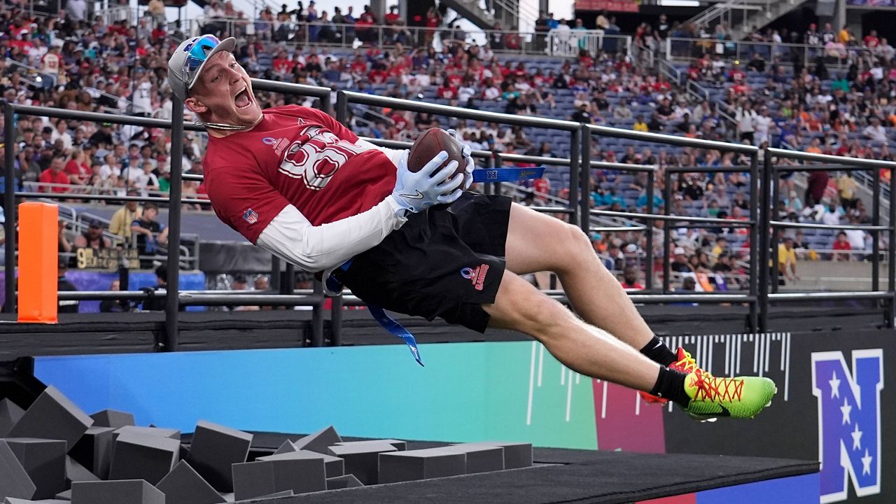 Arizona Cardinals tight end Trey McBride celebrates his touchdown jumping in a foam pit during the NFL Pro Bowl football game, Feb. 2, 2025, in Orlando, Fla. (AP Photo/John Raoux, File)