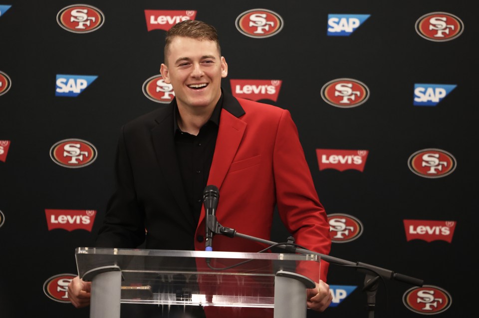 San Francisco 49ers quarterback Mac Jones speaks at a news conference.