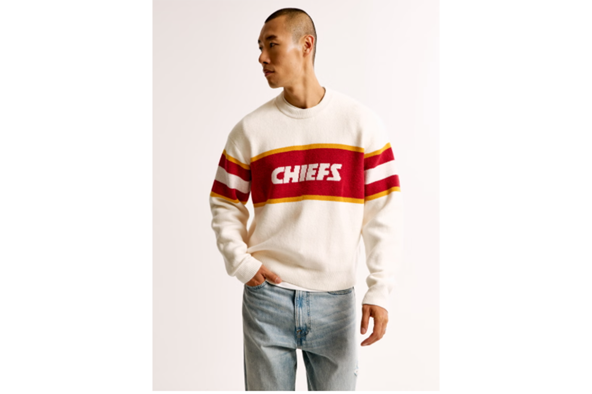 A man wearing a white and red Chiefs sweater.