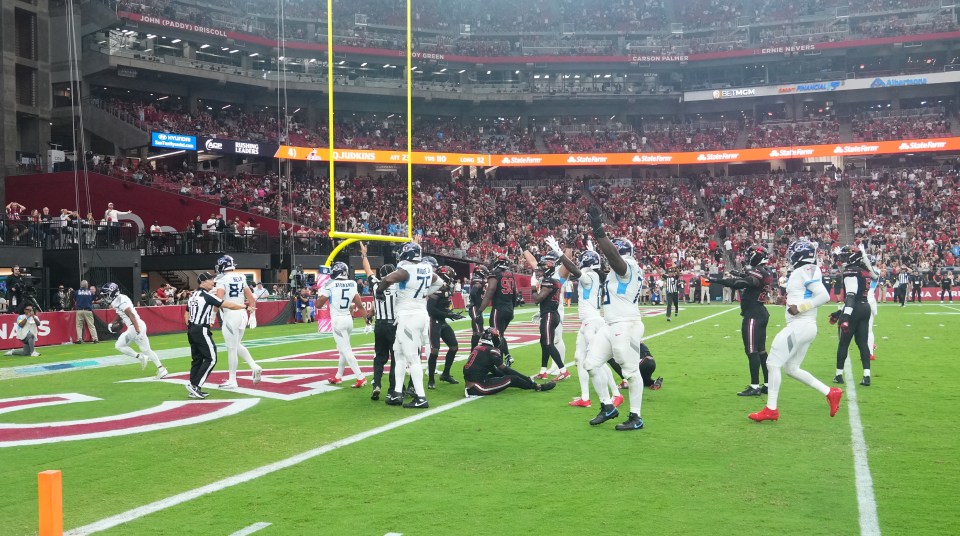Tennessee Titans players celebrate a touchdown in the end zone of State Farm Stadium.