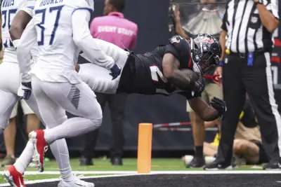 Sep 28, 2025; Houston, Texas, USA; Houston Texans running back Woody Marks (27) dives into the end zone for a touchdown during the fourth quarter against the Tennessee Titans at NRG Stadium. 