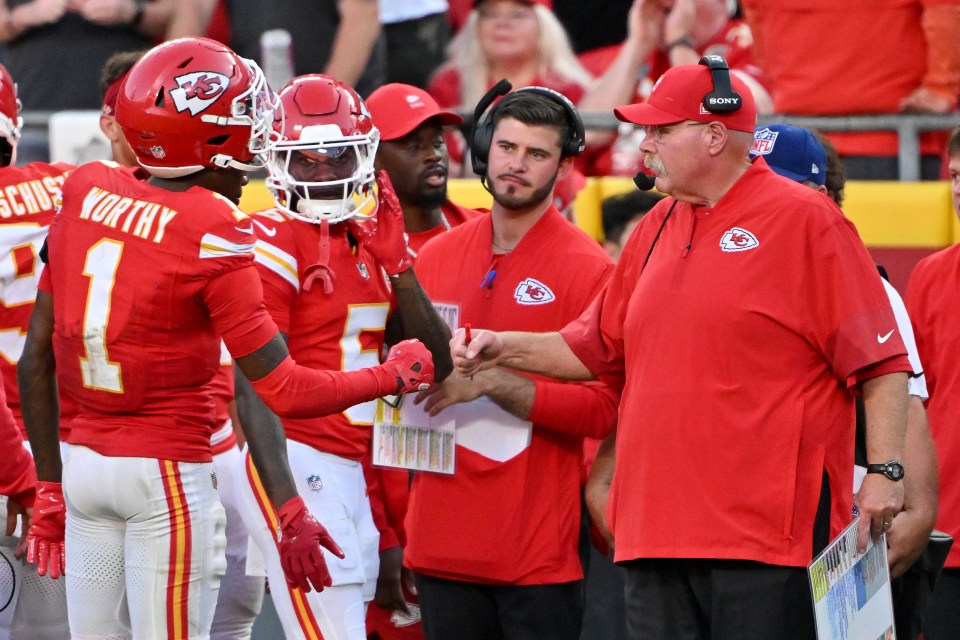 A picture of Andy Reid surrounded by several Chiefs players and coaches