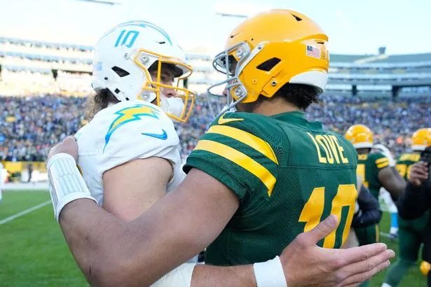 Justin Herbert #10 of the Los Angeles Chargers and Jordan Love #10 of the Green Bay Packers meet after the Packers beat the Charger 23-20 at Lambeau Field on November 19, 2023 in Green Bay, Wisconsin. 