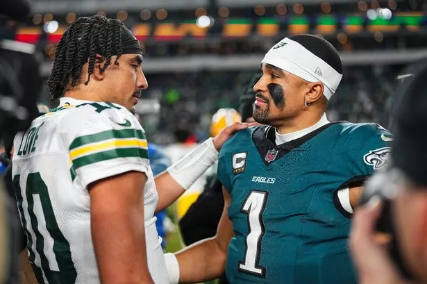 PHILADELPHIA, PA - JANUARY 12: Jalen Hurts #1 of the Philadelphia Eagles talks with Jordan Love #10 of the Green Bay Packers after an NFL football wild card playoff game at Lincoln Financial Field on January 12, 2025 in Philadelphia, Pennsylvania. (Photo by Cooper Neill/Getty Images)