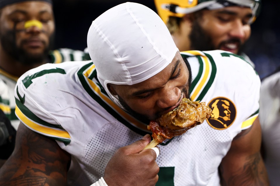 Micah Parsons eats a turkey after an NFL football game on Thanksgiving Day against the Detroit Lions at Ford Field on November 27, 2025 in Detroit, Michigan.
