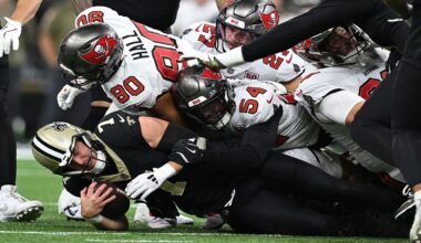 New Orleans Saints quarterback Taysom Hill (7) is sacked by Tampa Bay Buccaneers linebacker Lavonte David (54) and defensive end Logan Hall (90) during the second half of an NFL football game Sunday, Oct. 26, 2025, in New Orleans. (AP Photo/Ella Hall)