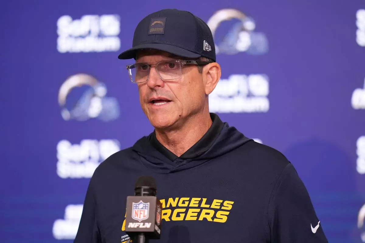 Los Angeles Chargers head coach Jim Harbaugh answers questions after an NFL football game against the Minnesota Vikings Thursday, Oct. 23, 2025, in Inglewood, Calif. (AP Photo/Gregory Bull)