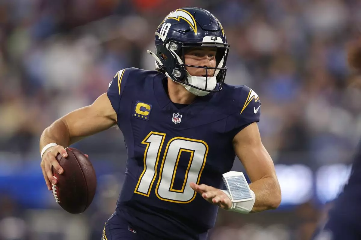 Los Angeles Chargers quarterback Justin Herbert (10) runs with the football during the first half of an NFL football game against the Minnesota Vikings Thursday, Oct. 23, 2025, in Inglewood, Calif. (AP Photo/Jessie Alcheh)