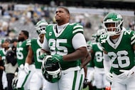 New York Jets defensive tackle Quinnen Williams (95) walks off the field with teammates...