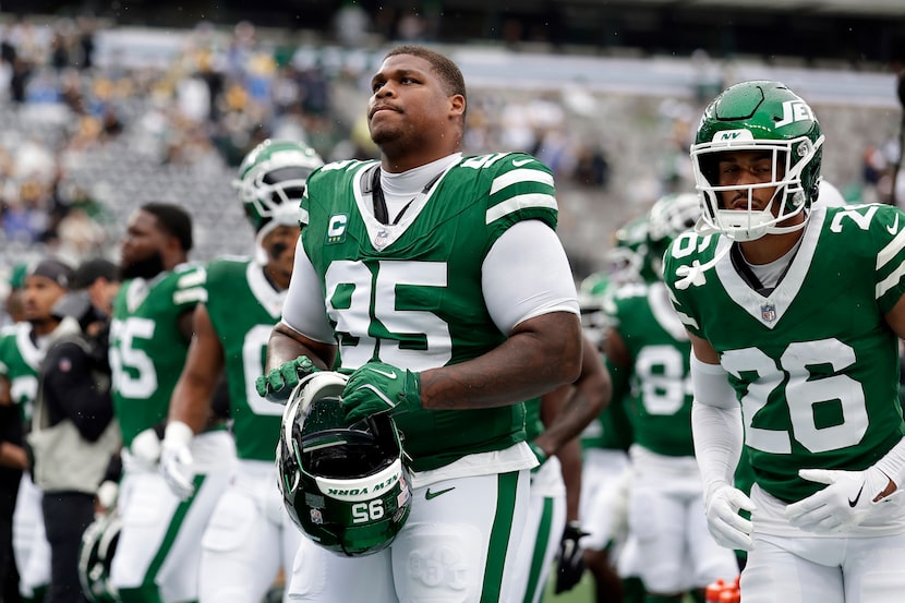 New York Jets defensive tackle Quinnen Williams (95) walks off the field with teammates...