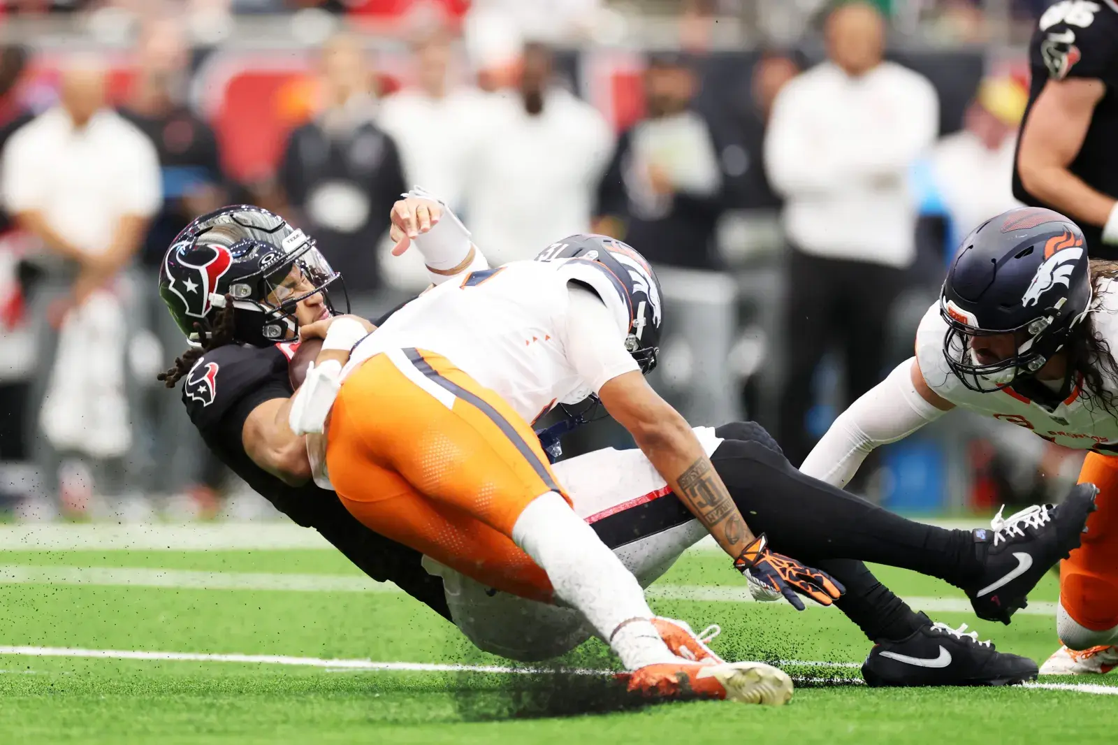 Houston Texans QB C.J. Stroud takes a hit from Denver Broncos CB Kris Abrams-Draine