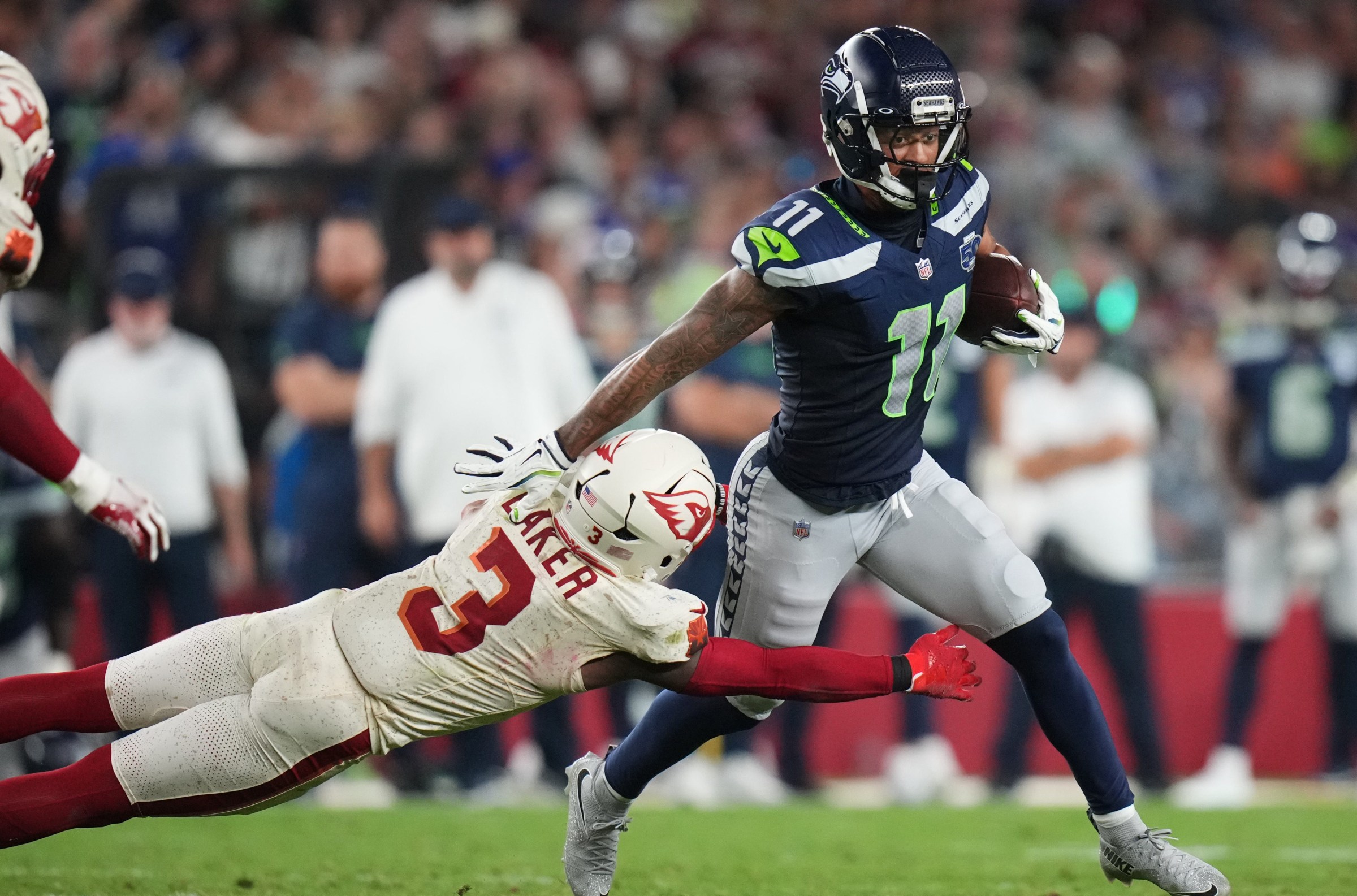 Arizona Cardinals safety Budda Baker (3) dives after Seattle Seahawks receiver Jaxon Smith-Njigba (11) at State Farm Stadium in Glendale on Sept. 25, 2025.