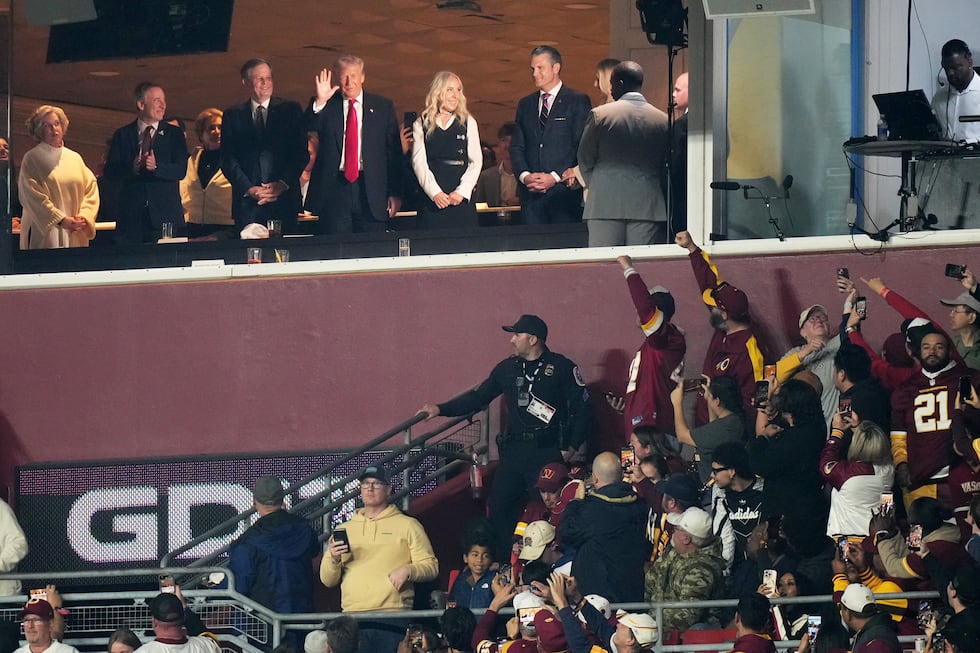 President Donald Trump is seen in a suite during the first half of an NFL football game...