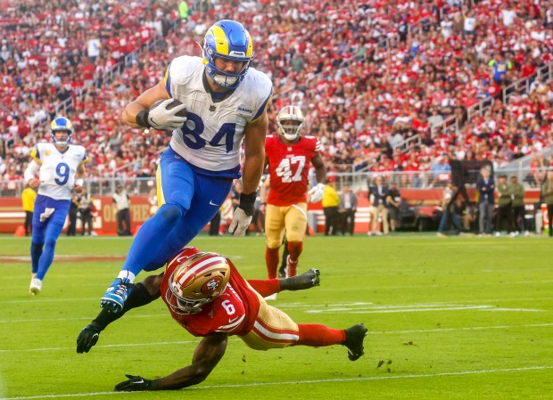 Los Angeles Rams' Colby Parkinson (84) runs with the ball against San Francisco 49ers' Malik Mustapha (6) during the fourth quarter at Levi's Stadium in Santa Clara, Calif., on Sunday, Nov. 9, 2025. (Shae Hammond/Bay Area News Group)