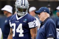 Dallas Cowboys owner Jerry Jones watches his team warmup with defensive end Marshawn...