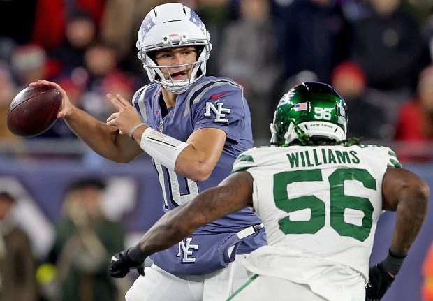 Foxboro, MA - Nov. 13 - New England Patriots quarterback Drake Maye (10) looks for the pass as New York Jets linebacker Quincy Williams (56) moves in during the second half at Gillette Stadium. (Photo By Matt Stone/Boston Herald).