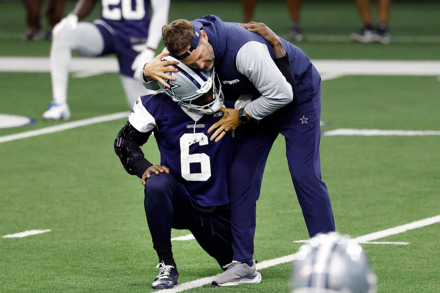 Dallas Cowboys head coach Brian Schottenheimer gives safety Donovan Wilson (6) a hug as they...