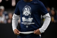 A Dallas Cowboys player wears a tribute t-shirt with Cowboys' Marshawn Kneeland on it prior...