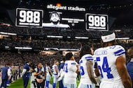 Dallas Cowboys players observe a moment of silence for defensive end Marshawn Kneeland...