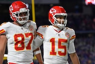 Kansas City Chiefs tight end Travis Kelce (87) and quarterback Patrick Mahomes (15) walk off...
