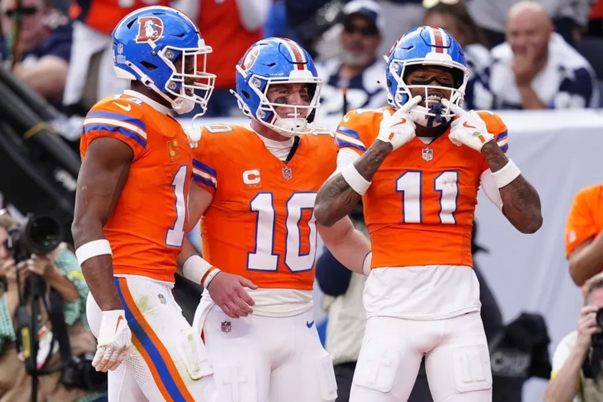 Oct 26, 2025; Denver, Colorado, USA; Denver Broncos wide receiver Troy Franklin (11) celebrates with wide receiver Courtland Sutton (14) and quarterback Bo Nix (10) after scoring a touchdown against the Dallas Cowboys in the fourth quarter at Empower Field at Mile High. Mandatory Credit: Ron Chenoy-Imagn Images