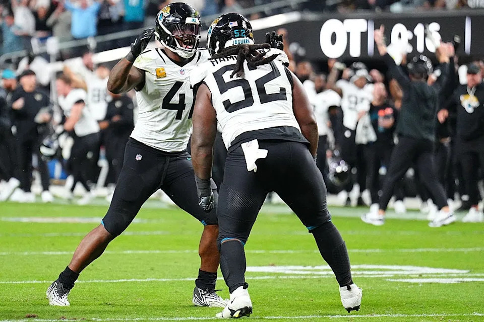 Jacksonville Jaguars defensive tackle DaVon Hamilton (52) is congratulated by teammate Josh Hines-Allen (41) after Hamilton knocked down a Geno Smith pass in overtime to preserve the Jaguars 30-29 victory over the Las Vegas Raiders on Nov. 2 at Allegiant Stadium in Las Vegas.