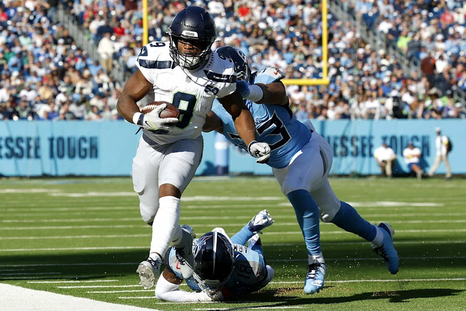 Kenneth Walker III (9) of the Seattle Seahawks is pushed out of bounds by Cedric Gray (33) of the Tennessee Titans in the first half of the game at Nissan Stadium on Nov. 23, 2025 in Nashville, Tenn.