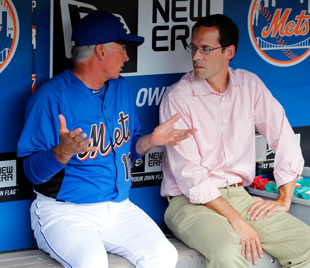 Terry Collins, in a blue Mets uniform, talks with Paul DePodesta, in a red-and-white checkered shirt, in the dugout.New York Mets manager Terry Collins talks with then-Mets VP of Player Development Paul DePodesta in the dugout before the game against the San Diego Padres in New York. 