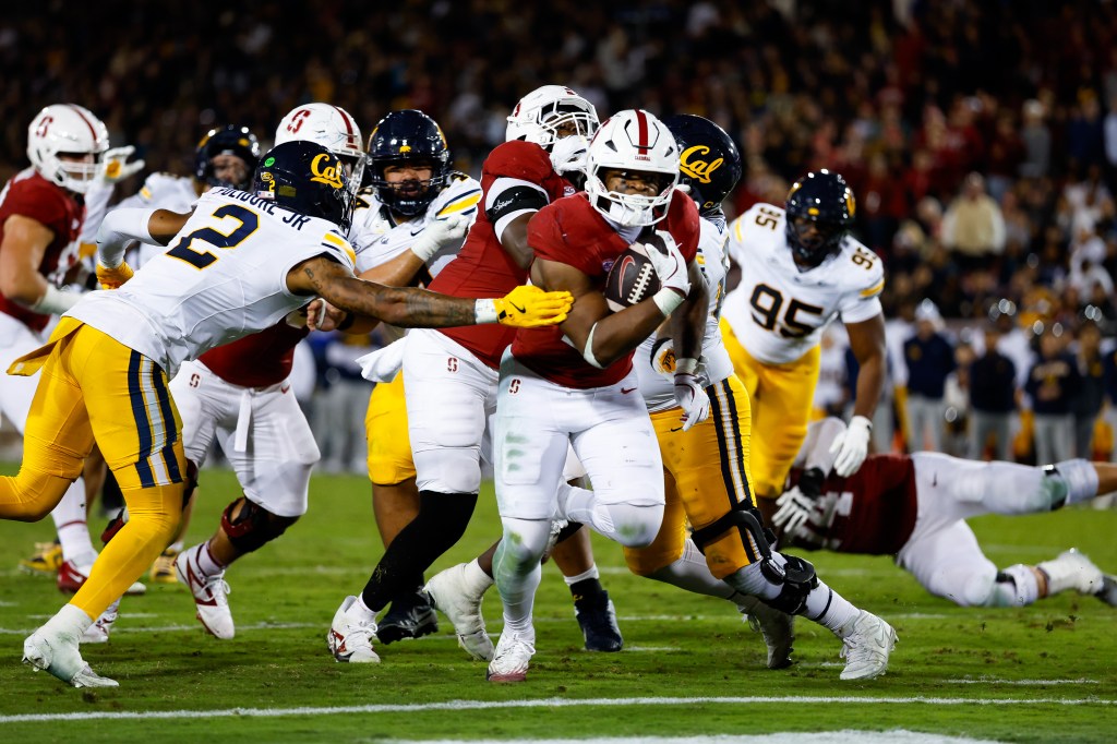 Nov 22, 2025; Stanford, California, USA; Stanford Cardinal running back Micah Ford (20) scores a touchdown during the fourth quarter against the California Golden Bears at Stanford Stadium. 