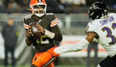 Cleveland Browns quarterback Shedeur Sanders (12) is pursued by Baltimore Ravens linebacker Tre ...