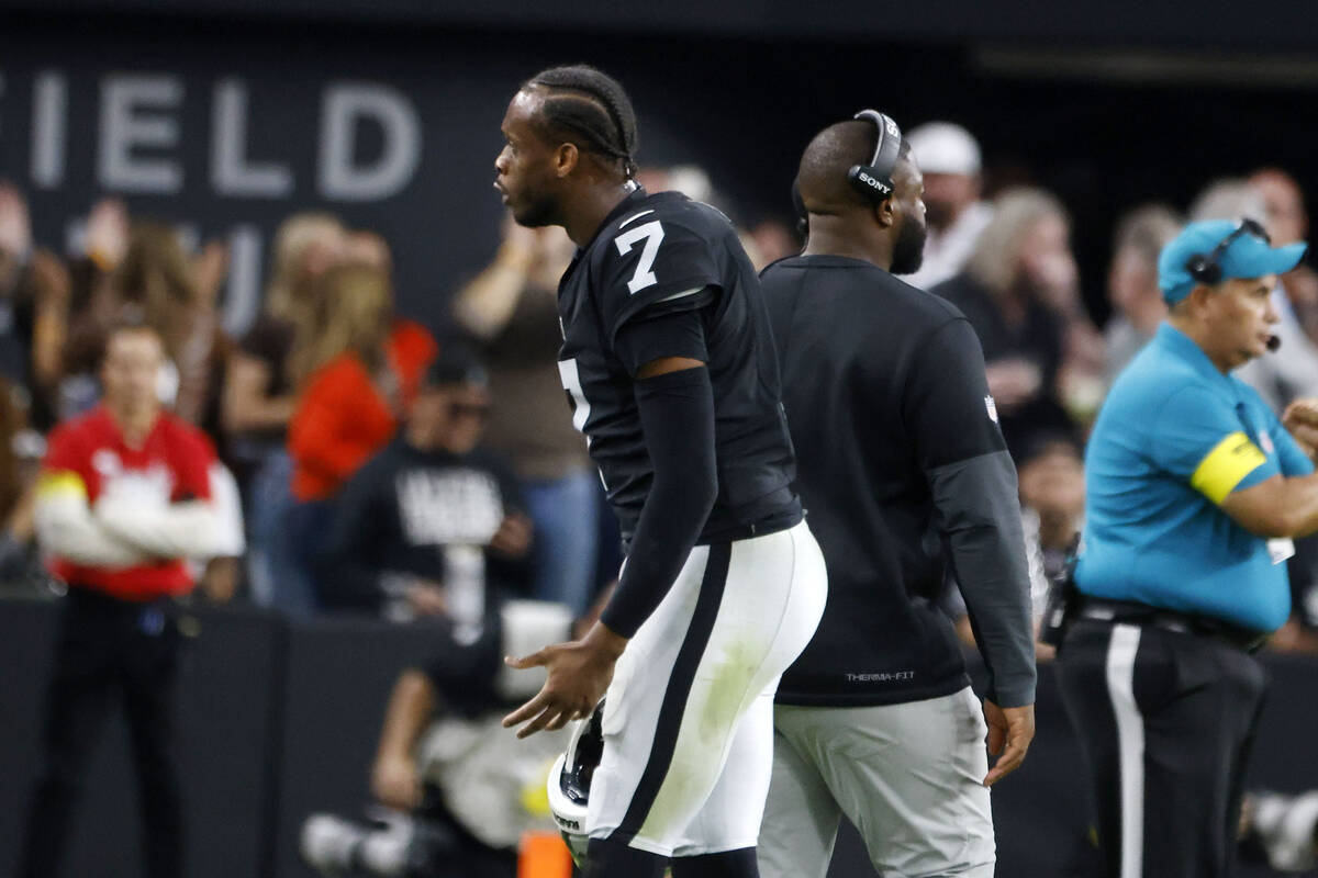 Raiders quarterback Geno Smith (7) argues with coaching staff as he leaves the field during an ...